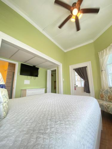 a bedroom with a bed and a ceiling fan at The Palms Hotel in Key West
