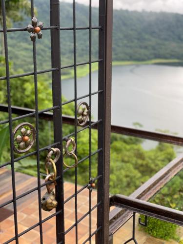a iron gate with a view of a lake at Casa maar -Treetop tent in Río Cuarto