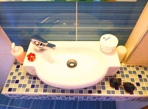 a white sink in a bathroom with at Stratos Hotel in Afitos