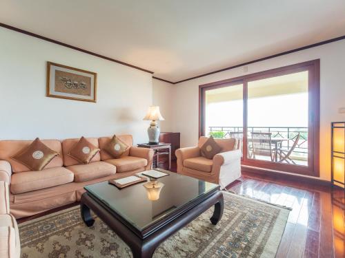 a living room with a couch and a table at Saigon Domaine Luxury Residences in Ho Chi Minh City