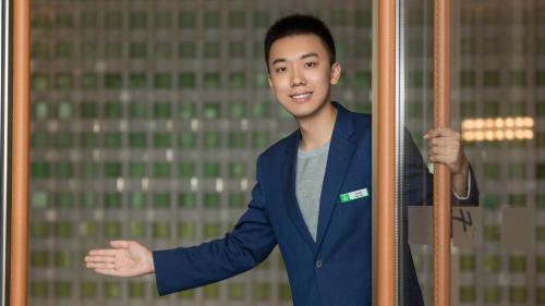 a young man in a blue suit holding a pole at Holiday Inn Xi'an Chanba by IHG-Near Xi'an International Convention Exhibition Center and Shopping mall and The Romantic show of Xi'an-Free Luggage Storage-English Service in Xi'an
