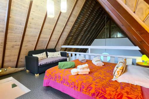 a room with a bed and a couch in a room at Villa Meheana in Moorea