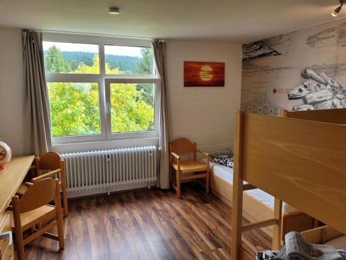 a small room with a bed and a window at Ferienwohnung Bergpanorama mit Pool in Sankt Englmar