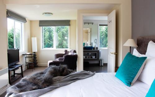 a bedroom with a bed with a dog laying on it at Queenstown Country Lodge in Queenstown