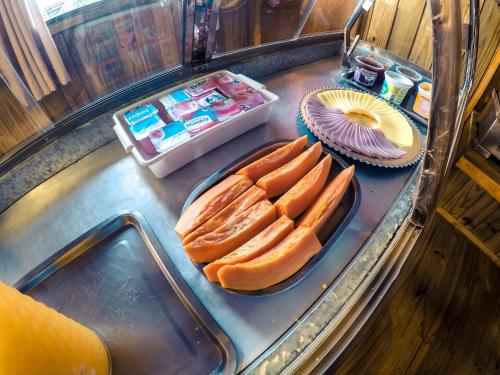 a counter with hot dogs and a plate of food at Hotel Guerra - Pousada Montebelo in Jaguaruna
