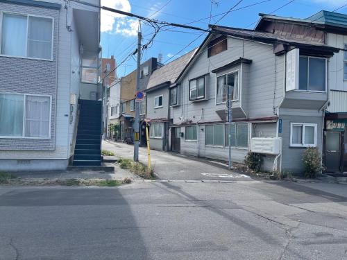 an empty street in a city with houses at City Otaru in Otaru