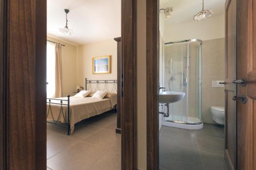 Grotte di CastroにあるAgriturismo PIAN DEL GRANO Azienda agricolaのベッドルーム1室(ベッド1台、シャワー、シンク付)