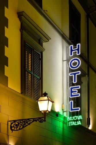 a neon sign on the side of a building at Hotel Nuova Italia in Florence