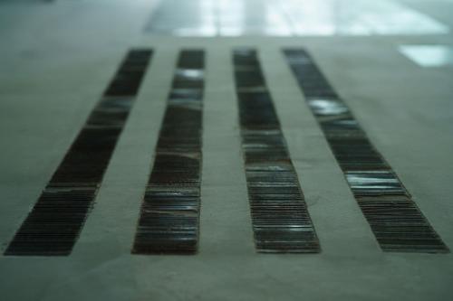 a row of black stripes on the floor at Seven Stories in Nagoya