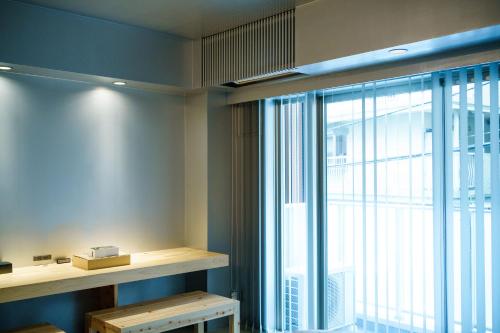a room with a large window and a book shelf at Seven Stories in Nagoya