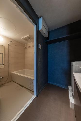 a bathroom with a tub and a sink and a shower at Seven Stories in Nagoya