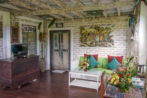 a living room with a couch and a tv at KTS Balinese Villas in Canggu