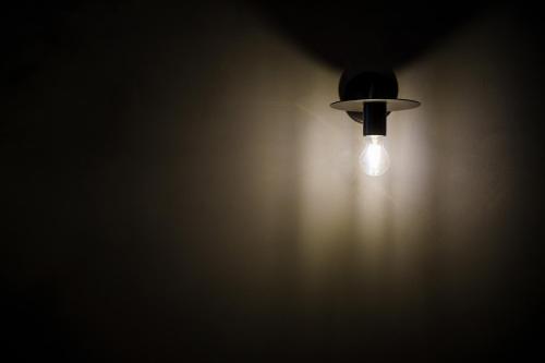 a light bulb in the corner of a dark room at Seven Stories in Nagoya