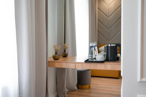 a room with a table with a coffee maker on it at Suite Hotel in Kemerovo