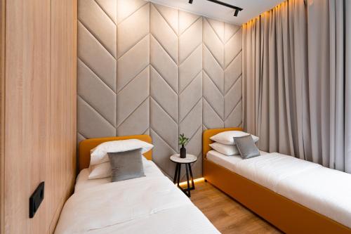 a room with two beds and a wall at Suite Hotel in Kemerovo