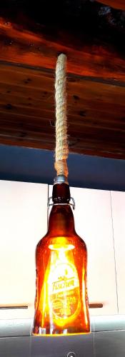 a bottle of honey is hanging from a ceiling at Casa Katina , villa in Lagana, Agrilia area in Laganas