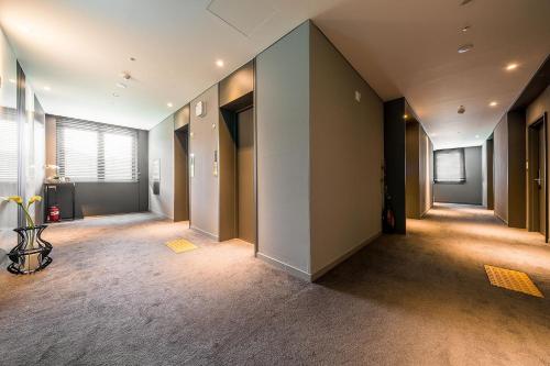 an empty hallway of an office with a large window at Crown Hotel Changwon in Changwon