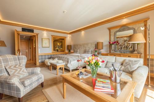 a living room with a couch and a table at Alpin Resort Sacher in Seefeld in Tirol