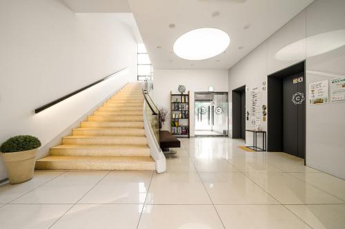 a hallway with stairs in a building at Crown Hotel Changwon in Changwon