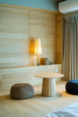 a table and a stool in a room at Seven Stories in Nagoya