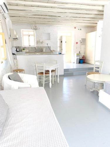 a white room with white furniture and a table at Anezina Village in Drios