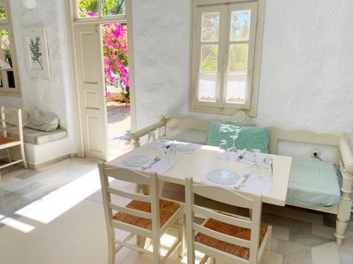 a room with a table and chairs and a bed at Anezina Village in Drios