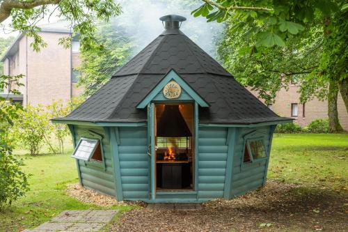 a blue dog house with a black roof at Summergrove Halls in Whitehaven