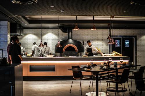 a group of chefs preparing food in a kitchen at Rydges World Square in Sydney