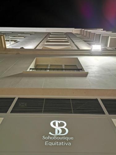 a large building with a sign on the side of it at Soho Boutique Equitativa in Málaga