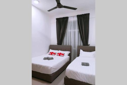 a bedroom with two beds and a ceiling fan at W58 WarmStay atGoldenHill NightMarket 2R WiFi CarPark in Tanah Rata