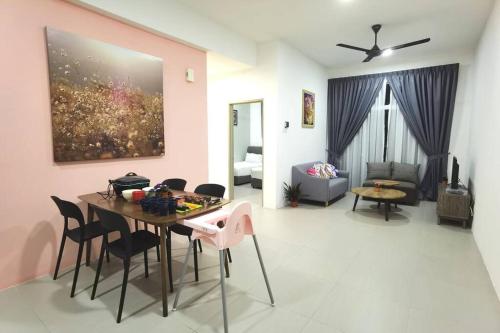 a dining room and living room with a table and chairs at W58 WarmStay atGoldenHill NightMarket 2R WiFi CarPark in Tanah Rata