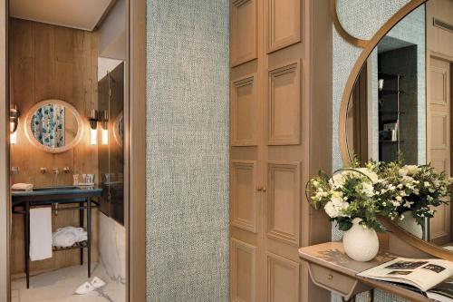 a bathroom with a vanity and a mirror and a sink at La Demeure Montaigne in Paris