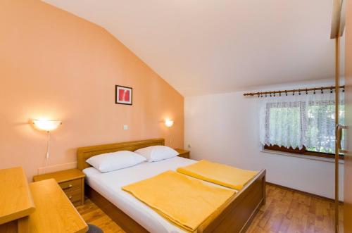 a small bedroom with a bed and a window at Two-Bedroom Apartment Crikvenica 5 in Dramalj