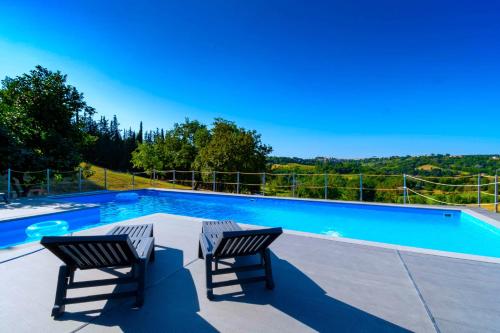 two chairs sitting next to a swimming pool at luxury villa Arianna in Tarano