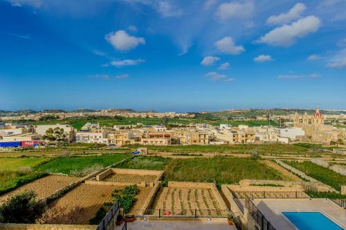 an aerial view of a city with buildings at Ta' Trudy Farmhouse in Sannat