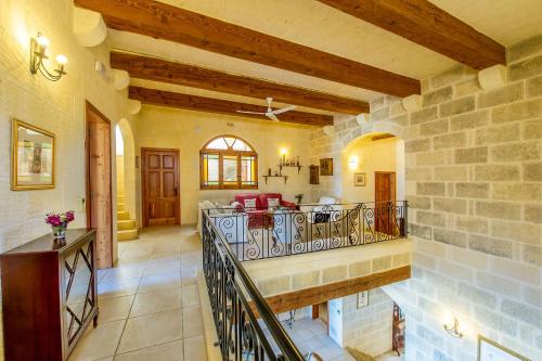 a large room with a stone wall at Ta' Trudy Farmhouse in Sannat