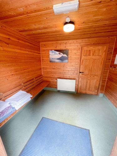 a room with a sauna with a wooden wall at Avon Tyrrell Outdoor Activity Centre in Bransgore