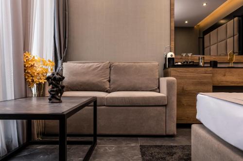 a living room with a couch and a table at SOHO Apart House in Plovdiv