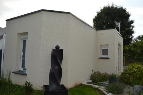une maison avec une statue devant elle dans l'établissement Studio agréable, au Havre