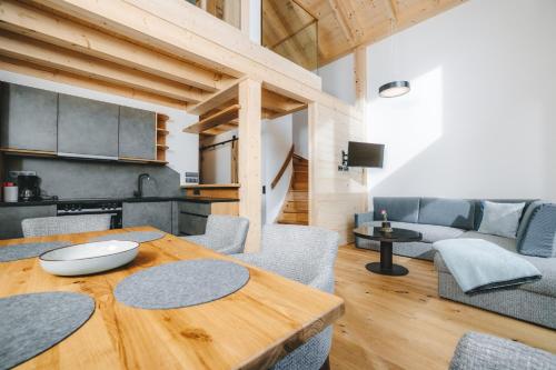 a kitchen and living room with a wooden table at zum Wohle in Oberwölz Stadt