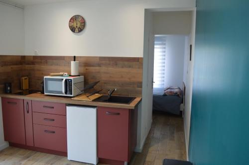 a kitchen with a microwave and a sink at Studio agréable in Le Havre