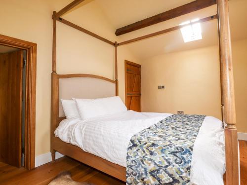 a bedroom with a four poster bed in it at Eagle Farmhouse in Glenridding