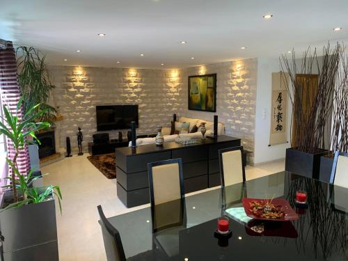 a living room with a glass table and a fireplace at The Sweet Dreams Holiday House in Azeitao