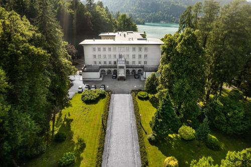 an aerial view of a large white building with a garden at Vila Bled in Bled
