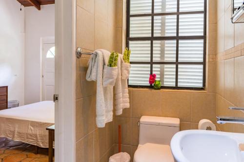 a bathroom with a toilet and a sink at Sea Foam Villa in Osbourn