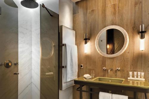 a bathroom with a sink and a mirror at La Demeure Montaigne in Paris