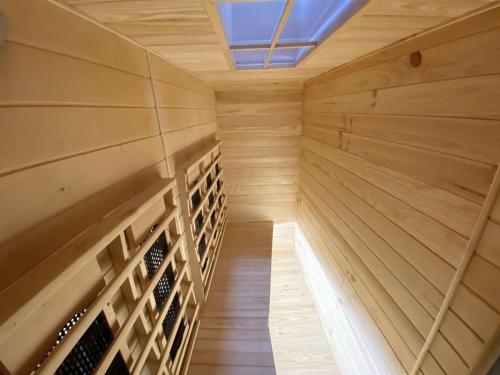 a wooden wine cellar with a ceiling at Le Clovis Suites Spa Sauna in Reims