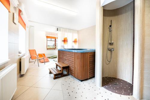a bathroom with a shower and a sink at Hotel Artaban in Žirovnice
