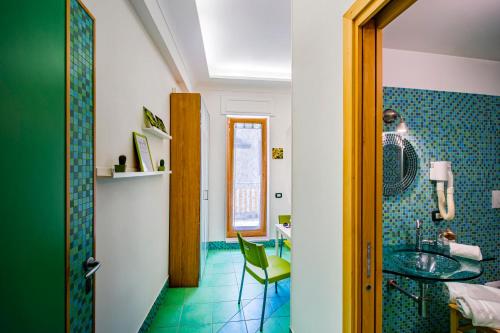 a bathroom with a sink and a table and a chair at Casa Evelina in Sant'Agnello