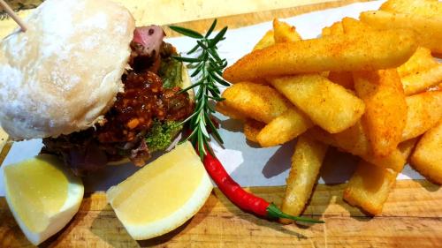a plate of food with a sandwich and french fries at MALI Boutique Lodge & Tube 'n Axe Budget Accommodation in Stormsrivier